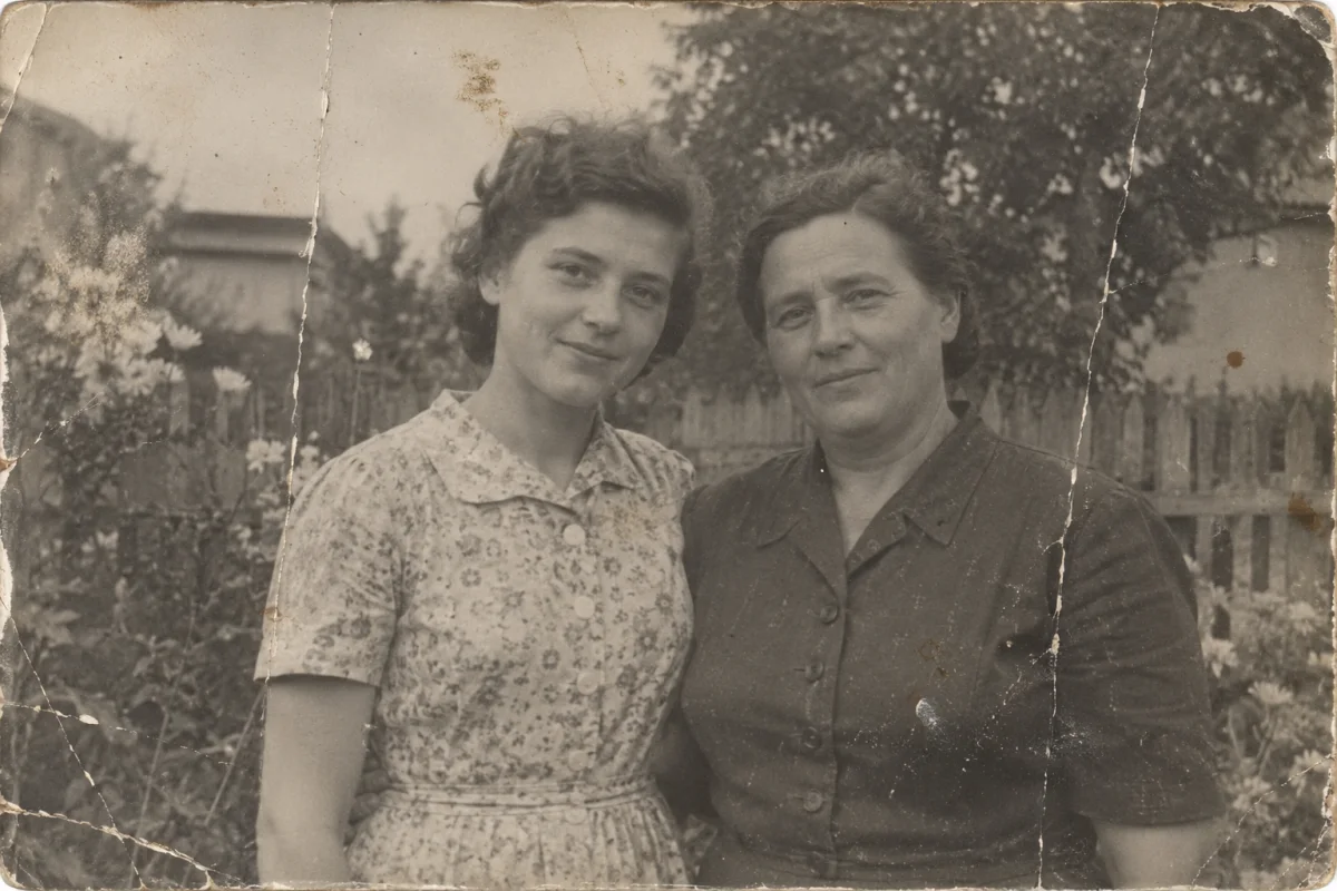 Faded family photograph with scratches and creases before restoration