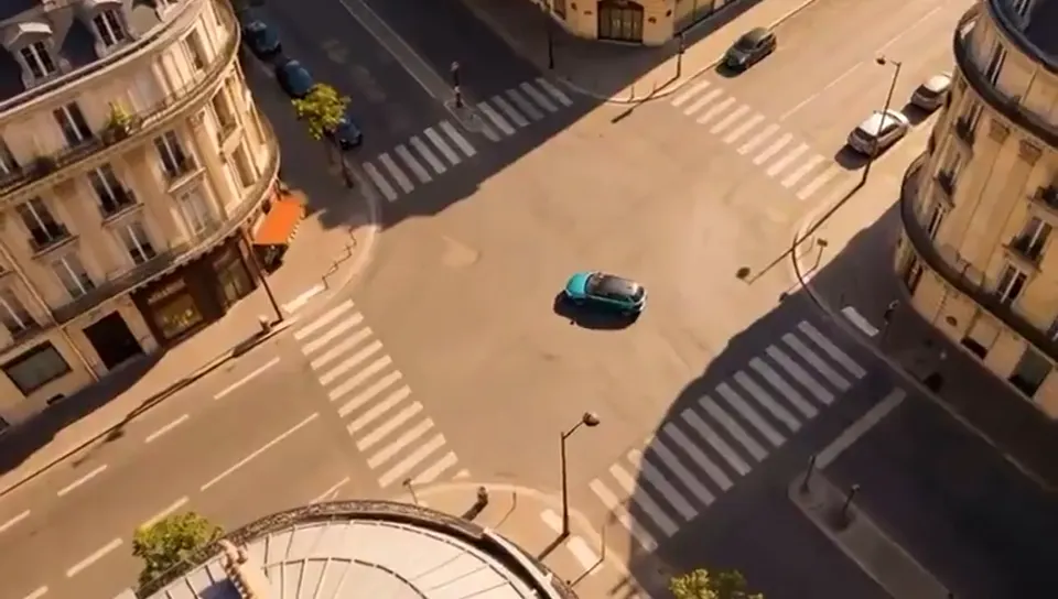 A teal car crossing a sunlit city intersection, a scene idea for an automotive ad
